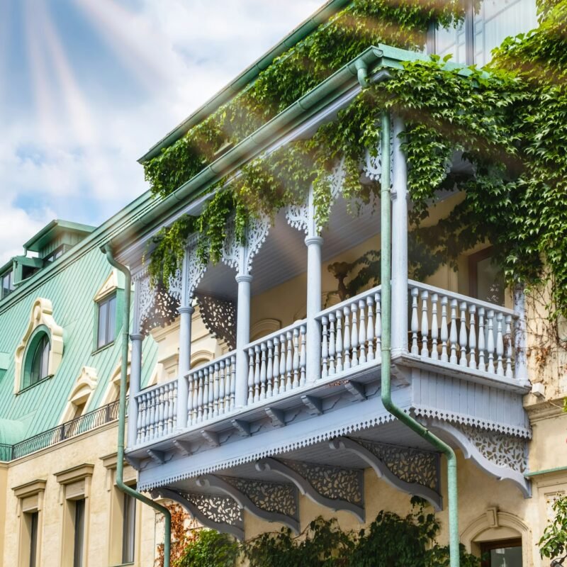 Carved wooden balcony and colorful buildings in historical Tbilisi, Georgia