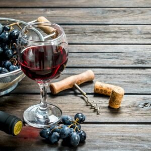 Wine background. Red wine in glasses with grapes.