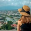 Woman in sun hat looking from panorama at Tbilisi city